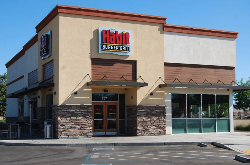 Freshly painted restaurant exterior with stone base and wood accent panels