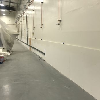 Freshly coated interior warehouse wall and sealed concrete floor at a Central Valley facility