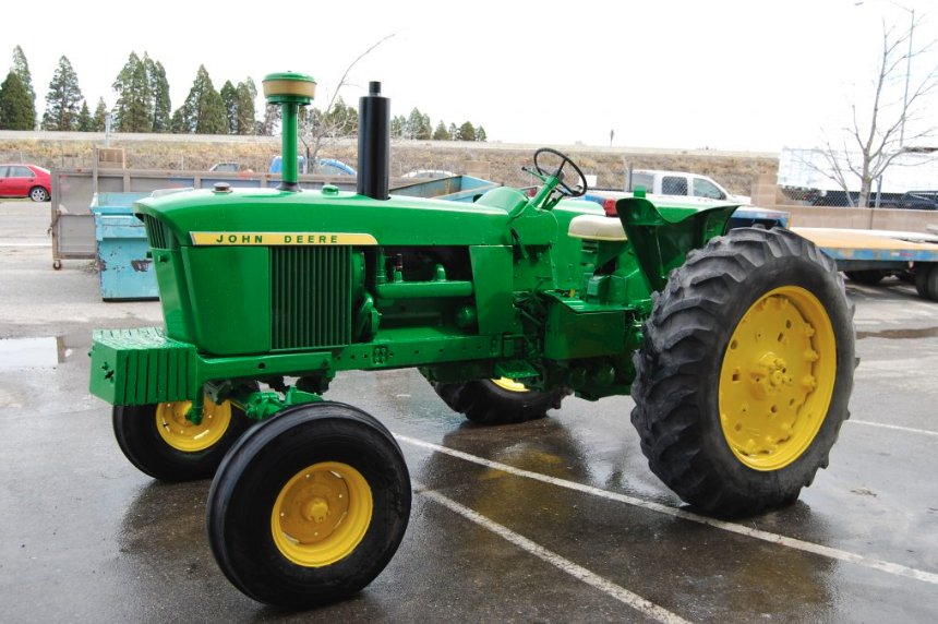 Restored John Deere tractor finished in green and yellow equipment coating