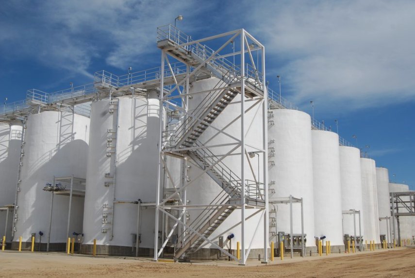 Coated storage tank farm with steel access stairs at an agricultural processing facility