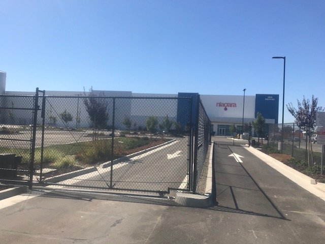 Beverage plant exterior and entry elevation finished in white and blue